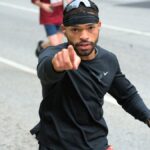 Focused marathon runner in downtown Baltimore participating in a race.