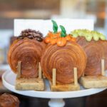 Gourmet pastries with decorative toppings on display in a New York bakery.