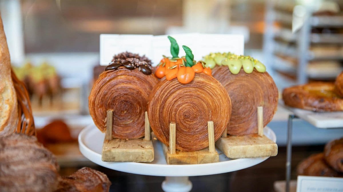 Gourmet pastries with decorative toppings on display in a New York bakery.