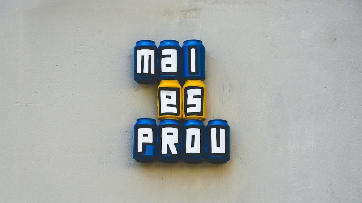 Creative wall art featuring cans spelling out words in bold colors.