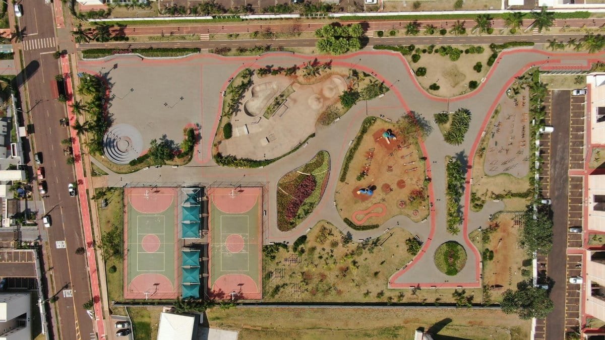 Aerial shot of a colorful park in Brazil featuring sports courts and recreational areas, showcasing urban design.