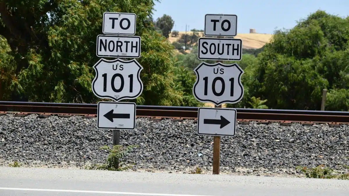 Directional signs for US Route 101 seen in San Miguel, California during a sunny day.
