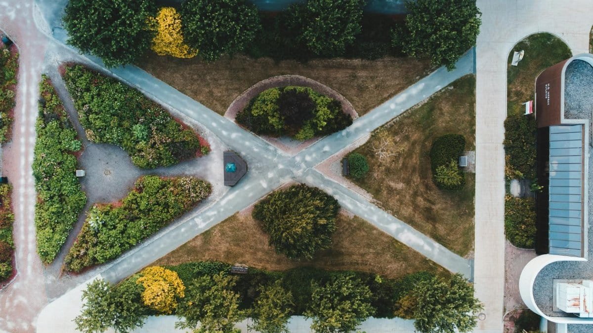 Explore symmetrical garden pathways captured from above with lush greenery.