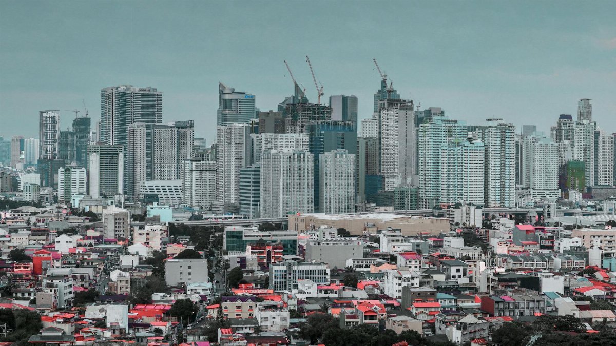 Panoramic view of the bustling cityscape of Pasay City with a skyline of skyscrapers and urban residential areas.