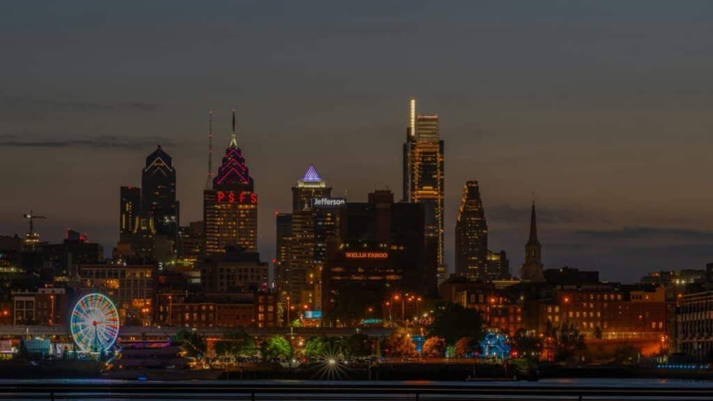 Stunning view of Philadelphia skyline illuminated at night with a Ferris wheel.