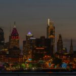 Stunning view of Philadelphia skyline illuminated at night with a Ferris wheel.