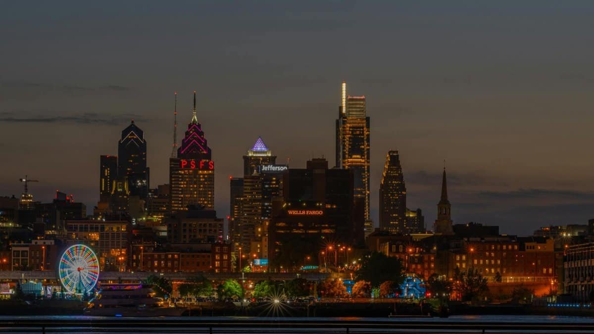 Stunning view of Philadelphia skyline illuminated at night with a Ferris wheel.