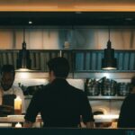 Chefs working in a bustling New York kitchen, evening scene.