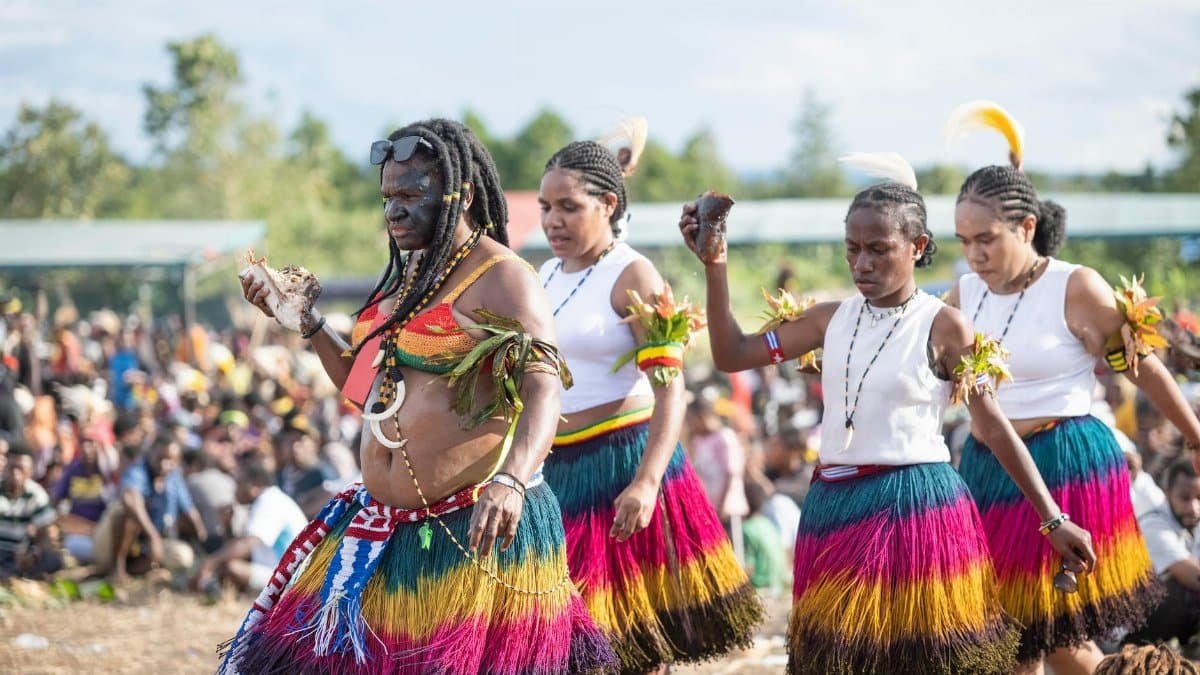 A vibrant display of traditional dance with colorful attire at a cultural festival outdoors.