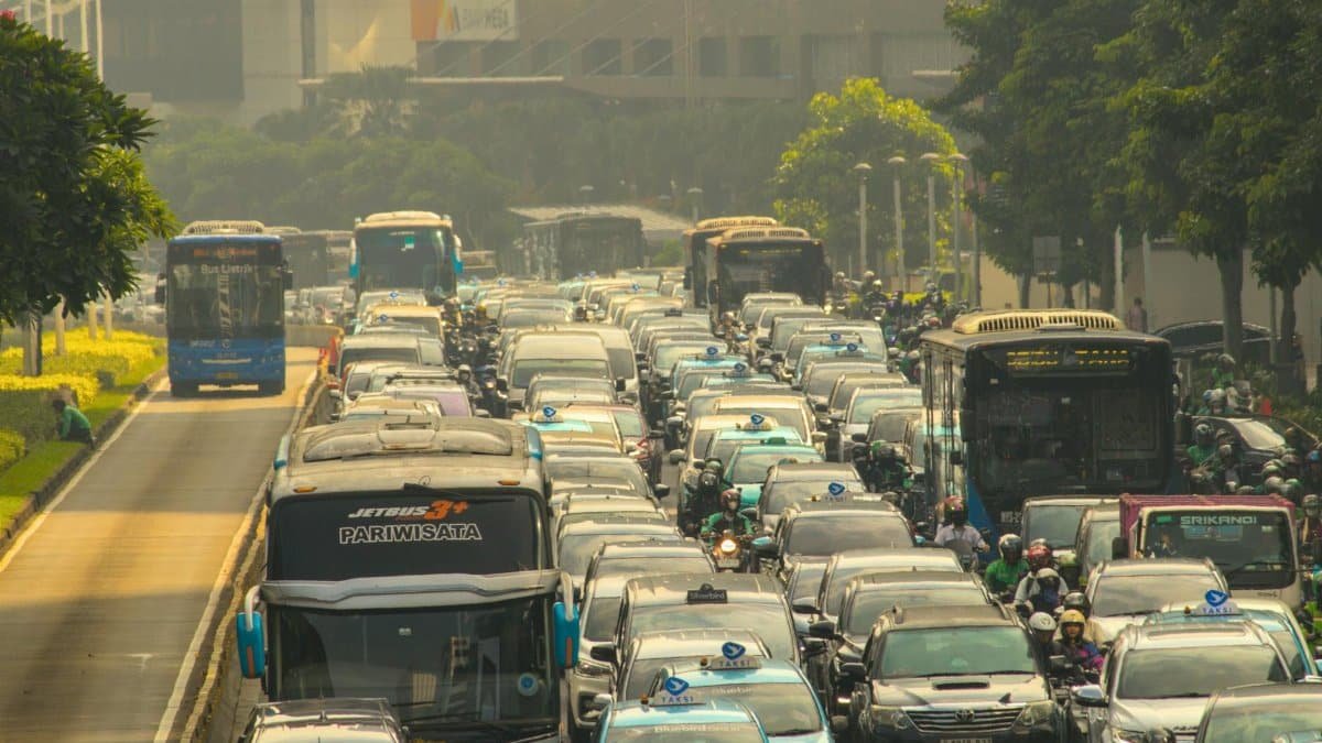 Heavy traffic jam in Jakarta's congested streets during daytime, showcasing urban life challenges.