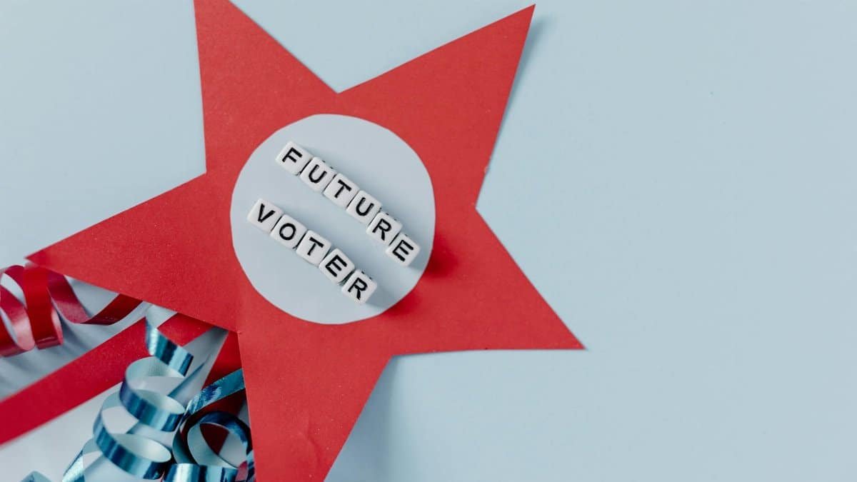 Red star decoration with 'Future Voter' text and blue ribbons on a light background.