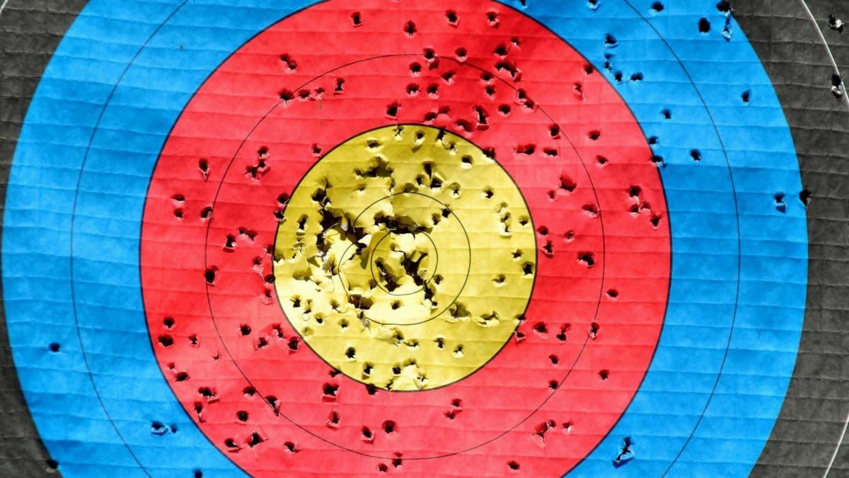 Vibrant archery target showcasing accuracy with multiple hits across colored rings.