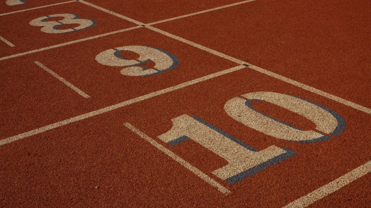 Detailed view of athletics track lanes with numbers eight, nine, and ten.