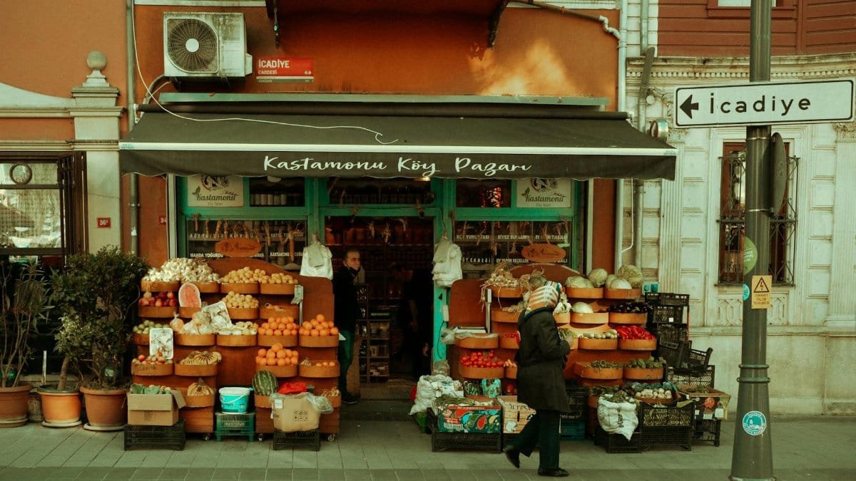 Street market stall displaying fresh fruits and vegetables in a vibrant neighborhood setting.