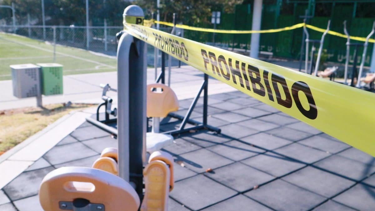 Yellow caution tape blocks access to outdoor gym equipment in Oaxaca, Mexico.