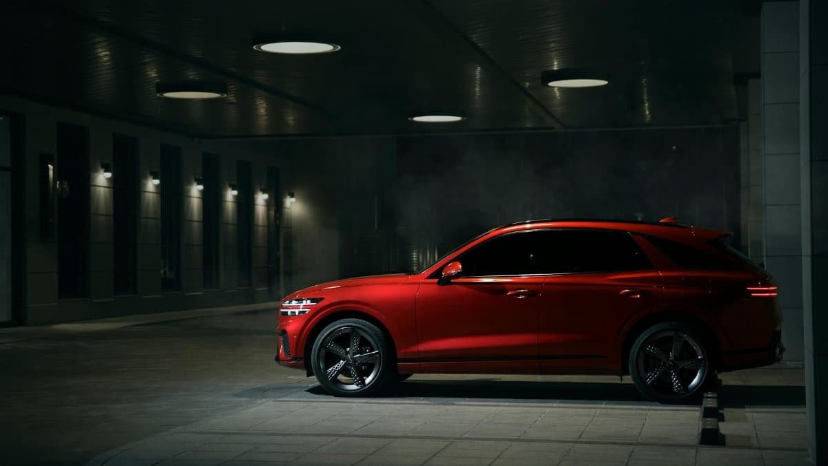 Luxurious red SUV parked in a dimly lit garage, showcasing elegance and sophistication.