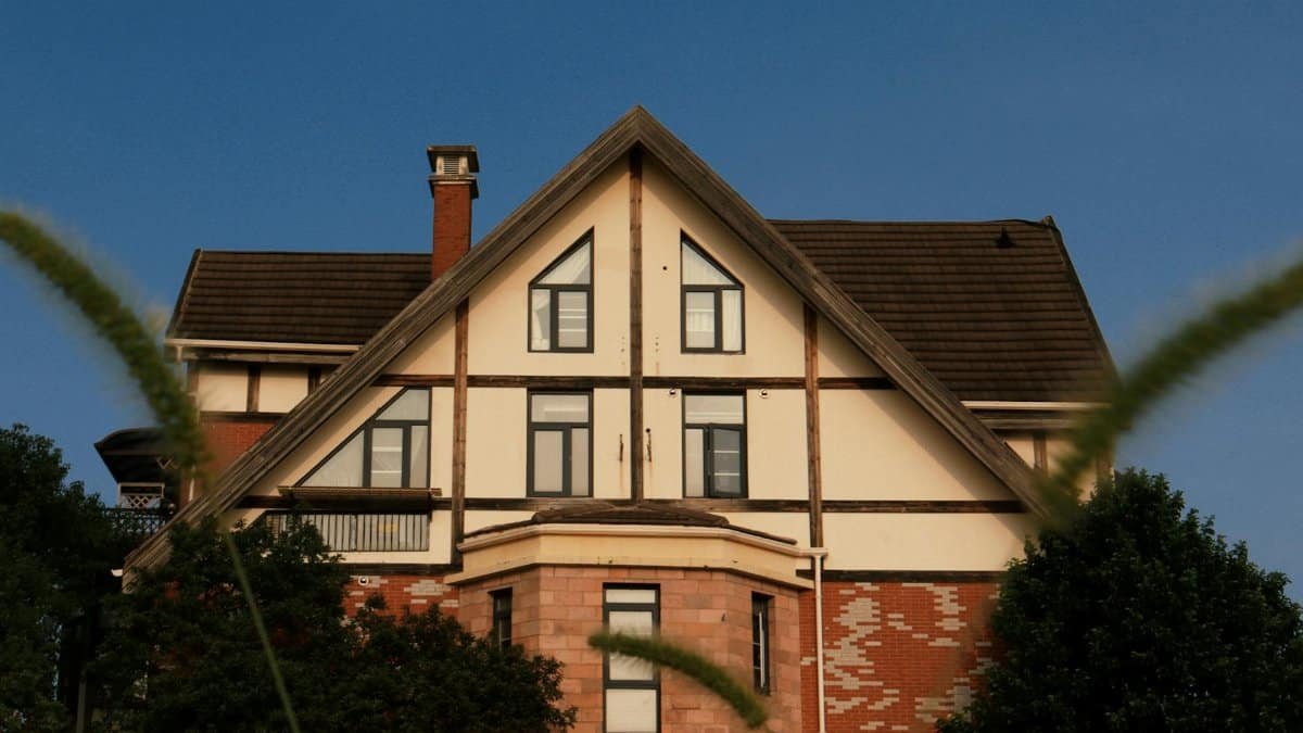 Beautiful Tudor-style house with gable roof, captured on a sunny day. Ideal for architecture and real estate imagery.