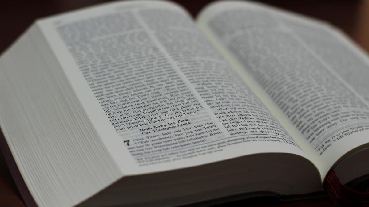 Open Bible with visible text, highlighting scripture details.