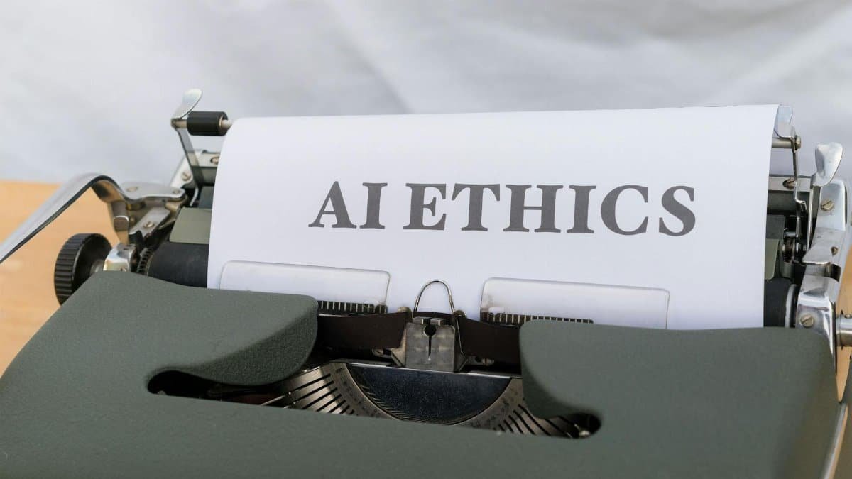 Close-up of vintage typewriter with 'AI ETHICS' typed on paper, emphasizing technology and responsibility.
