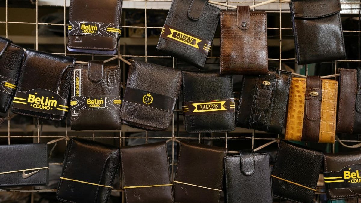 Collection of leather wallets on a market rack, showcasing diverse designs and finishes.