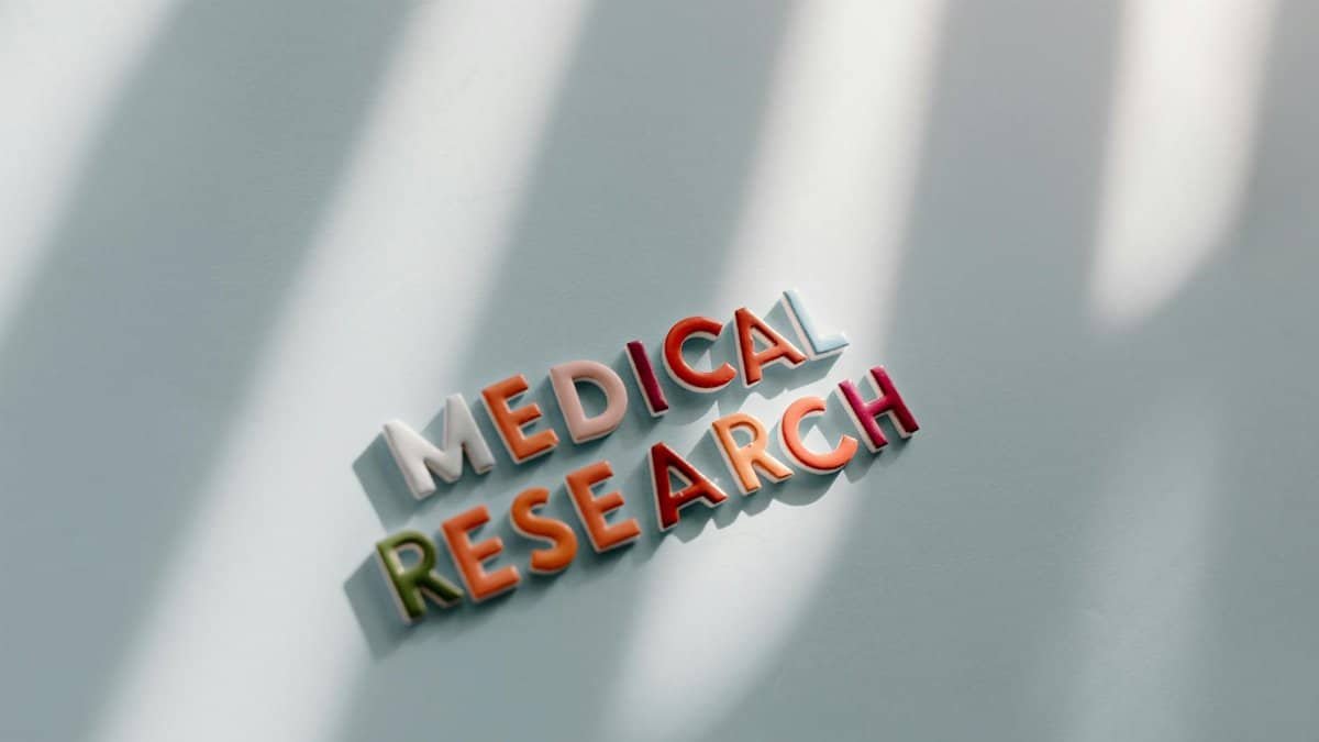 Creative representation of medical research with colorful letters and shadows.