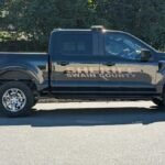 Swain County Sheriff pickup truck parked outdoors in daylight. Side view capture.