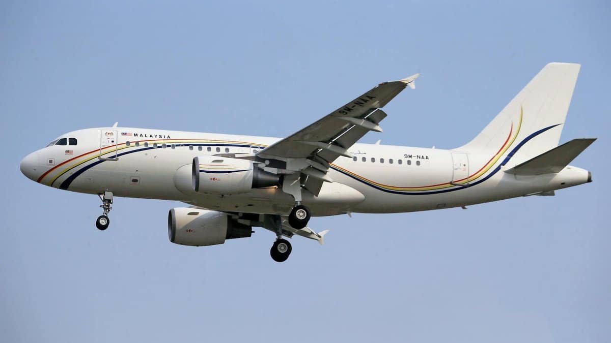 Royal Malaysian Air Force Airbus A319 jet flying against a clear blue sky.