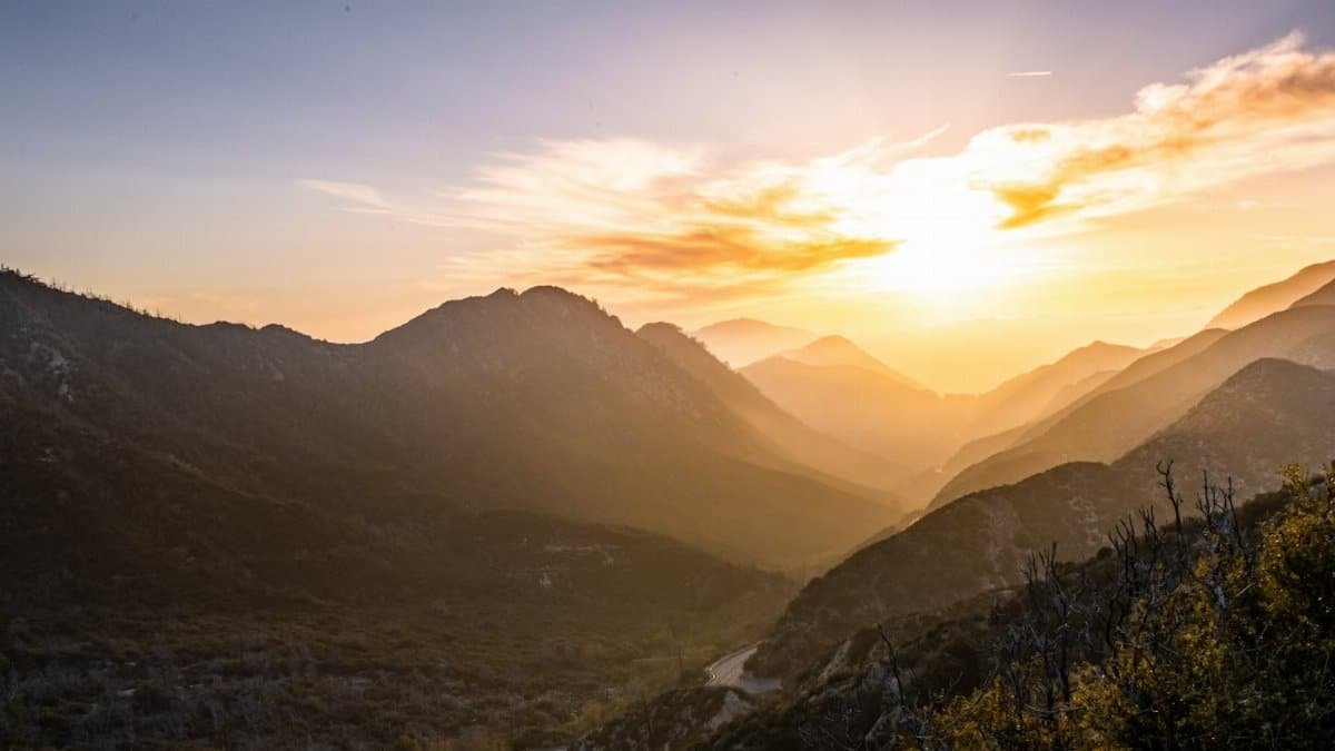 Stunning sunset over the San Gabriel Mountains in California, capturing warm tones and majestic landscapes.