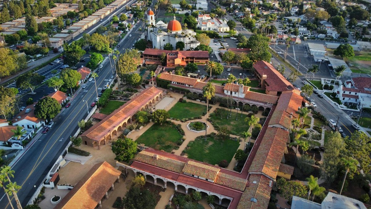 Aerial view of Mission San Juan Capistrano showcasing its historic architecture and lush gardens.