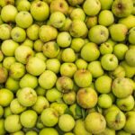 Top view of a large collection of fresh green apples, perfect for food and agriculture themes.