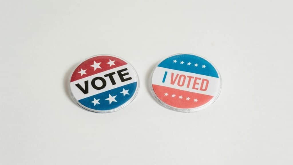 Red, white, and blue political buttons with 'Vote' and 'I Voted' text for election and civic engagement themes.