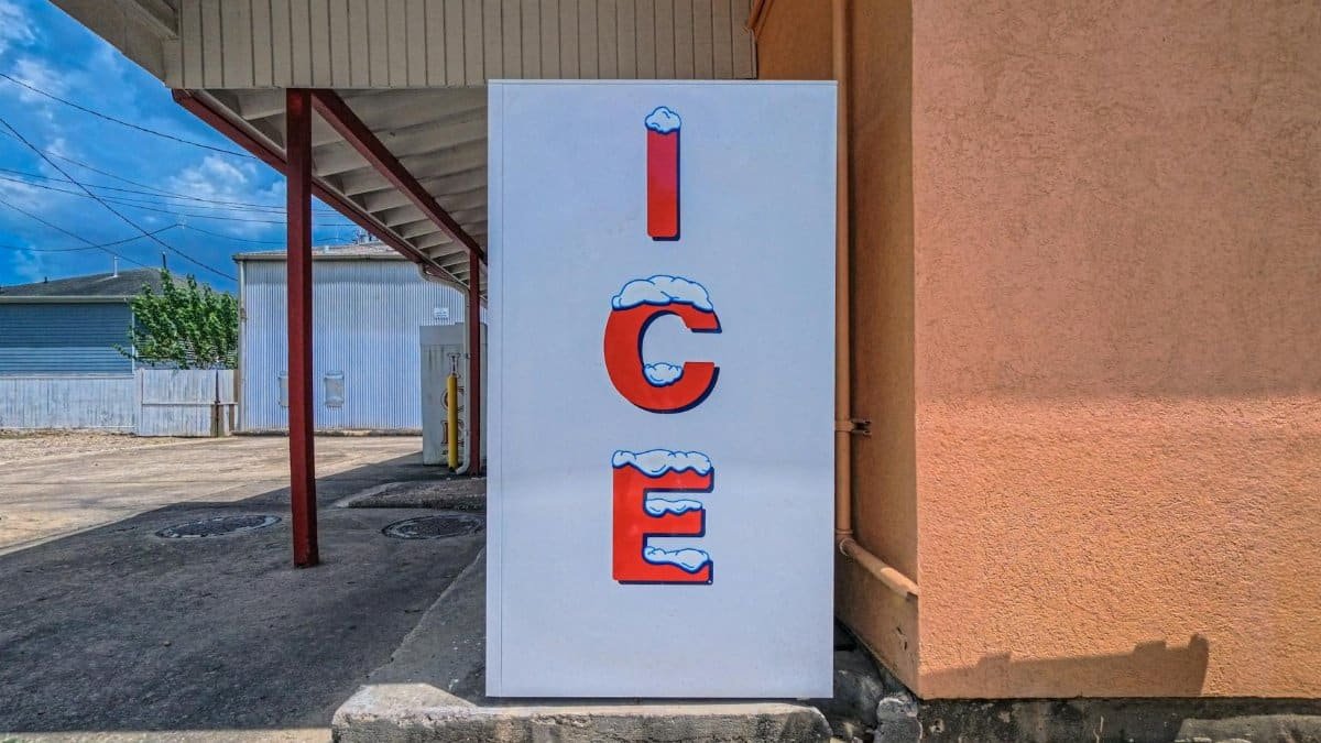 Outdoor ice machine with bright signage in Houston, TX on a sunny day.