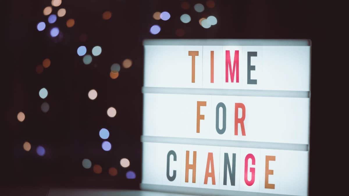 Illuminated lightbox sign displaying 'Time for Change' with a bokeh background, conveying transformation.