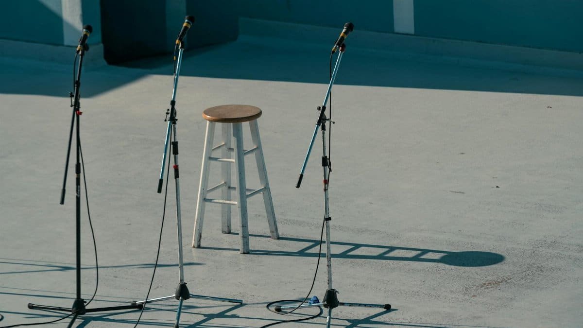 A serene outdoor stage setup featuring a bar stool and microphones in Vancouver, Canada.