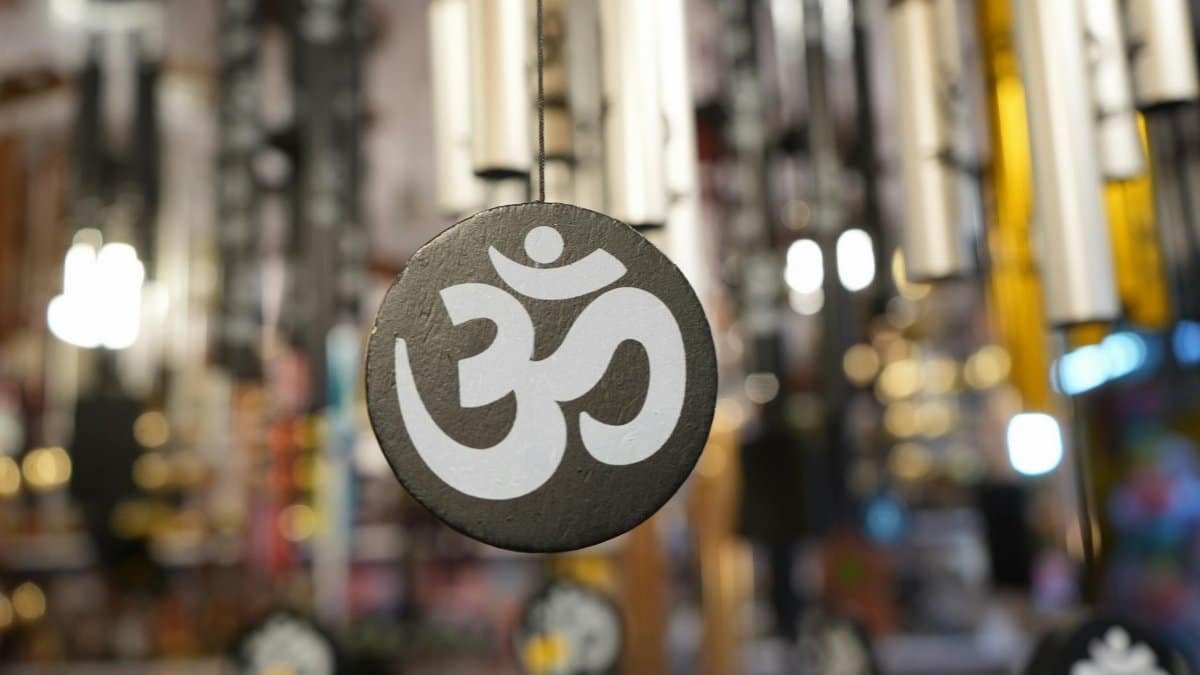 Close-up of a decorative Om symbol on a hanging ornament, perfect for spiritual and meditative themes.