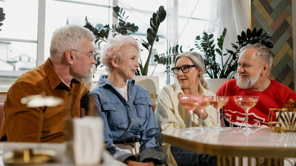 Close-up of senior adults having a joyful conversation at a social gathering indoors.