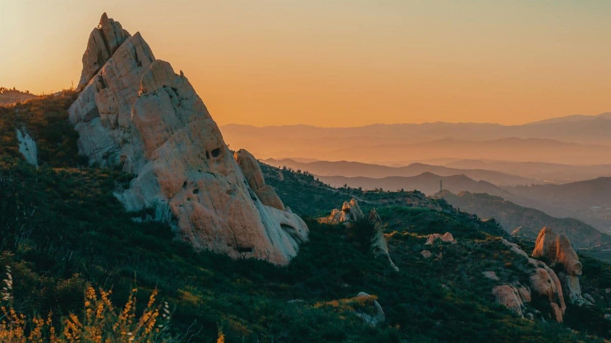 Explore the breathtaking rock formations and mountain views at sunset in Malibu's serene landscape.