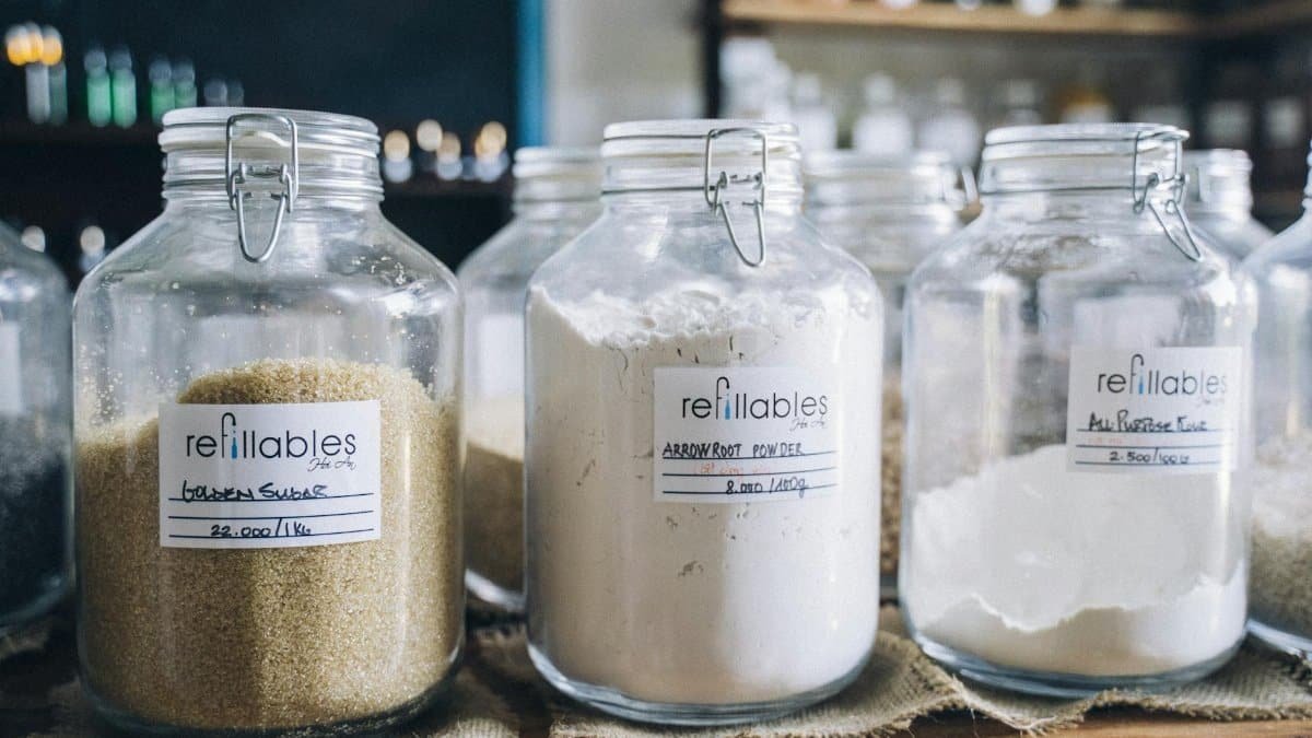 A variety of bulk organic ingredients in refillable glass jars at an eco-friendly store.