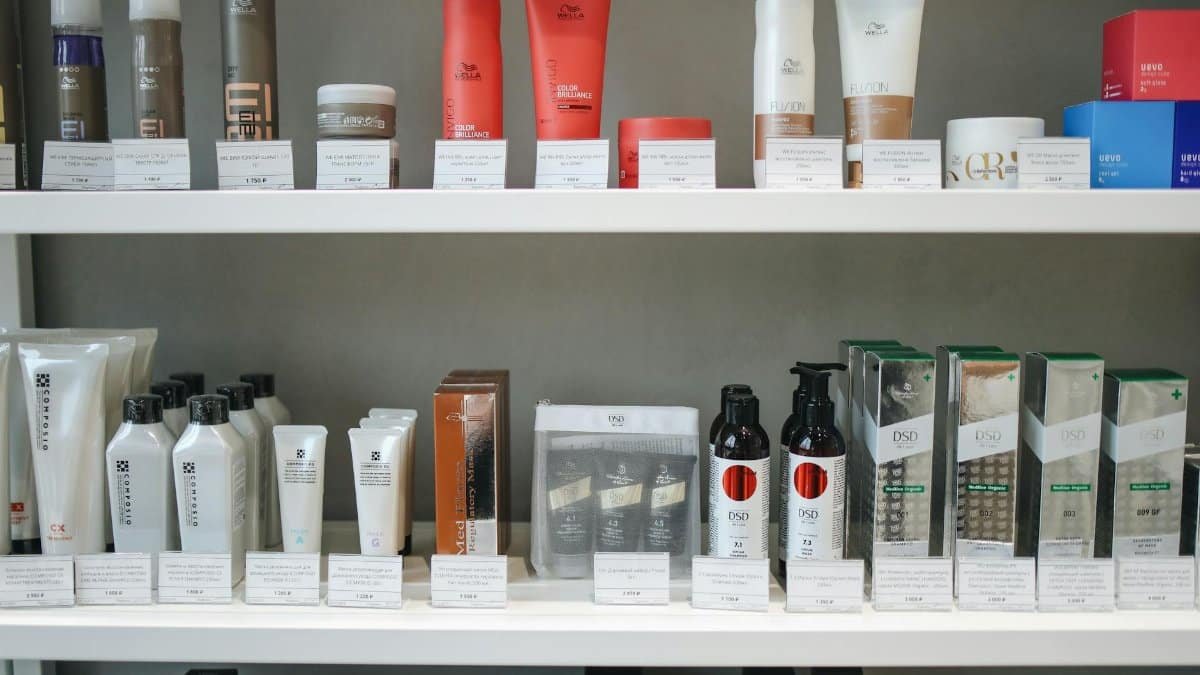 Assorted skincare and beauty products neatly displayed on shelves in a store setting.