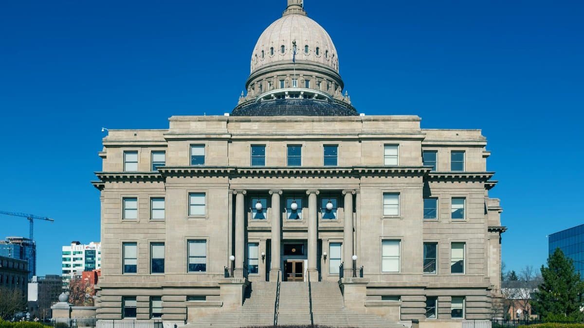 Front view of the historic Idaho State Capitol Building under blue skies in Boise.