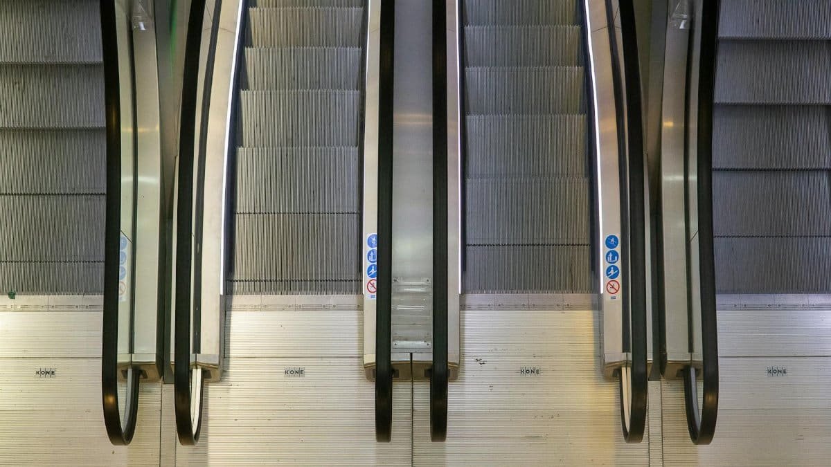 Aerial perspective of escalators in a Rotterdam building, showcasing industrial design and symmetry.