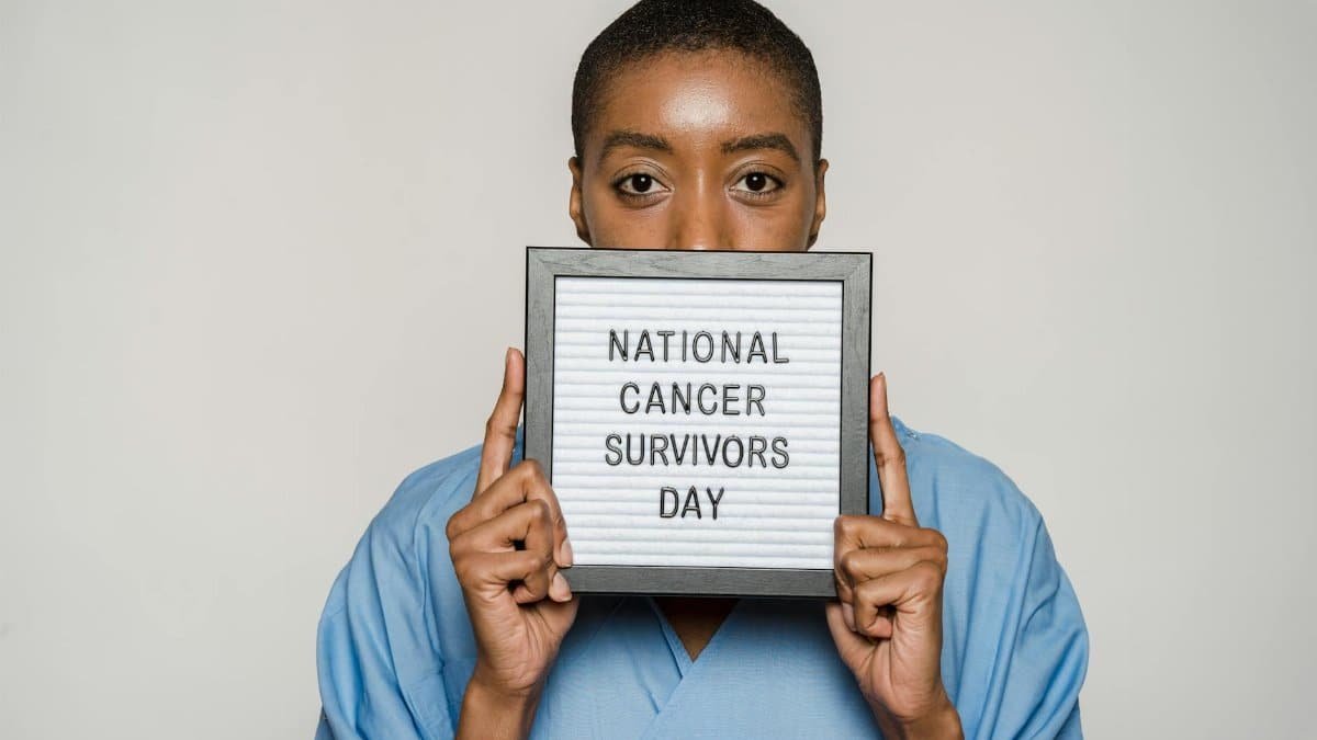 Portrait of a strong woman celebrating National Cancer Survivors Day with a message of hope.