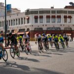 Group of cyclists in a street race through downtown Redlands, CA.