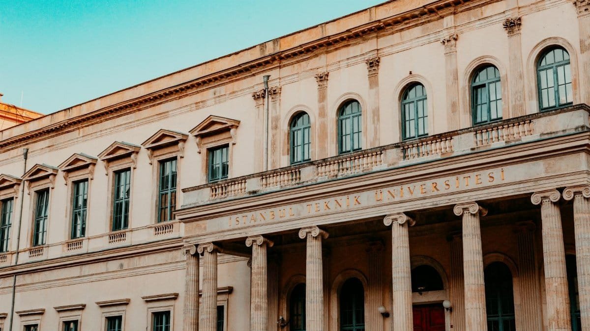 Facade of Istanbul Technical University with classic columns and windows.