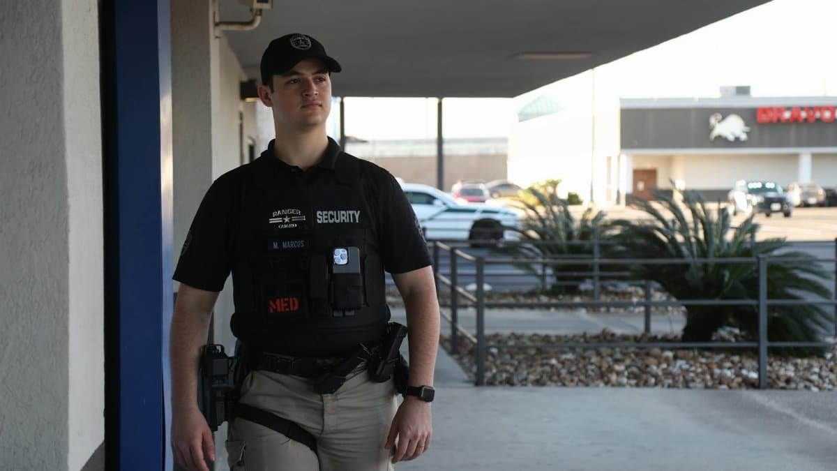 A security guard patrolling an outdoor area in League City, Texas, ensuring safety during the day.