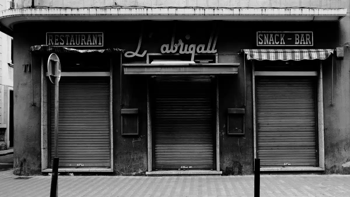 Moody black and white photo of a closed restaurant in Barcelona.