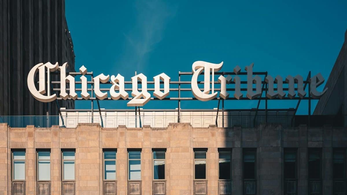 Close-up of Chicago Tribune Building architecture under a clear blue sky.
