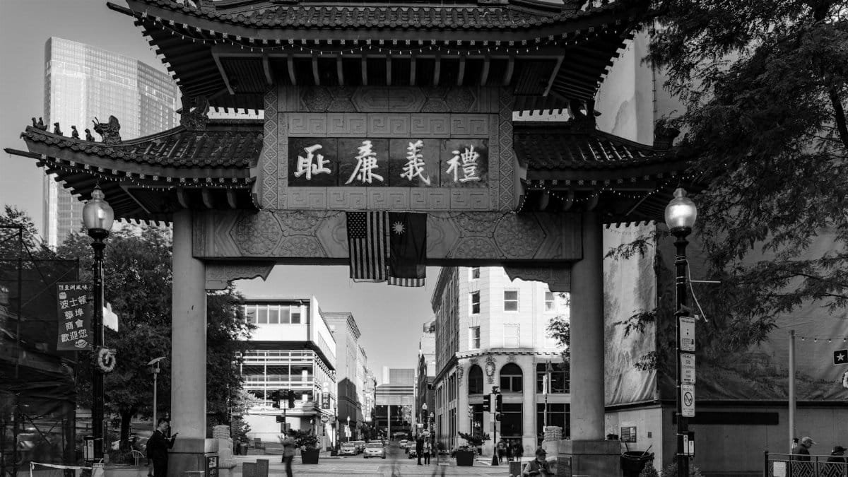 Monochrome view of the iconic Boston Chinatown Gate with cityscape.