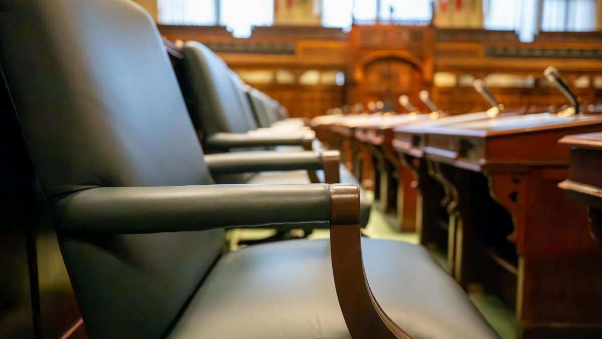 Elegant courtroom seating with leather chairs and wooden desks, exuding a sense of authority.