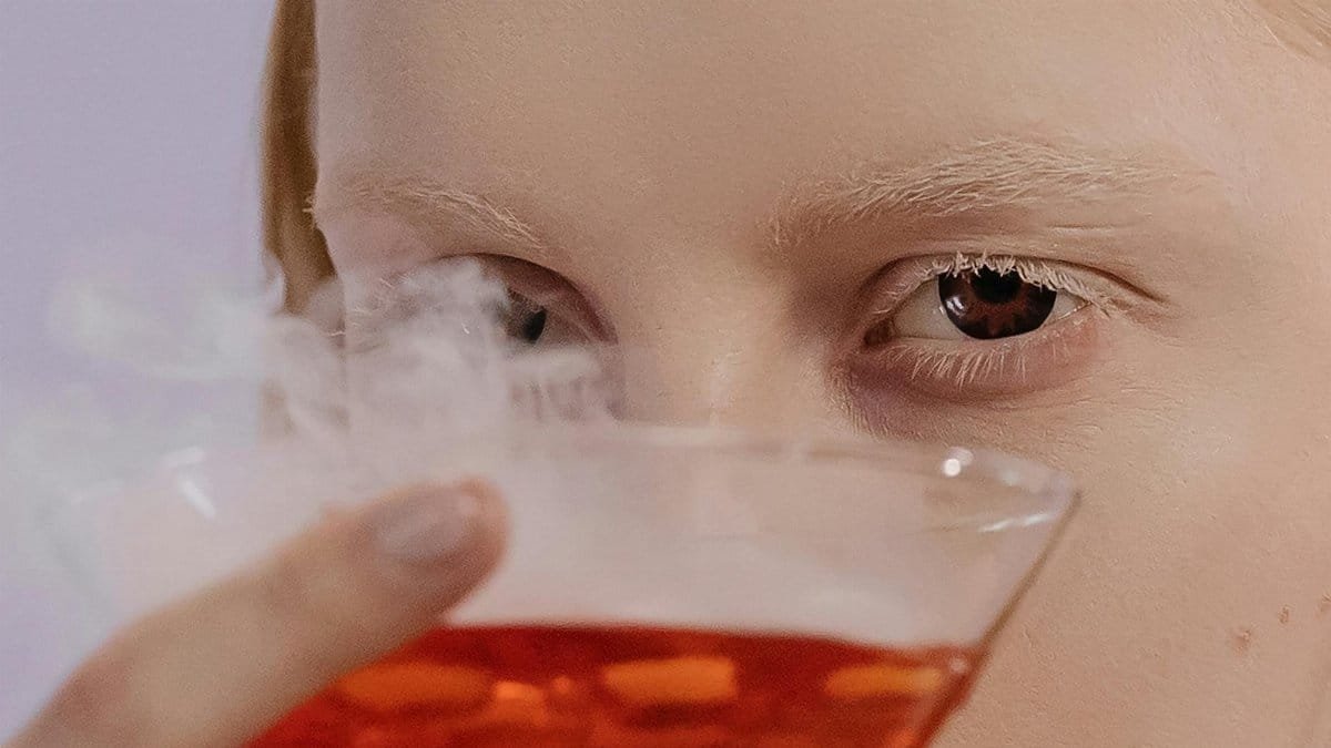 A spooky cocktail with dry ice smoke, perfect for Halloween festivities.